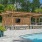 a pool with chairs and a gazebo by a building