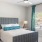 a bedroom with a bed and a fan