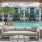 a pool with a lounge chair and a lounge chair in front of it