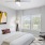 a bedroom with a bed and a fan